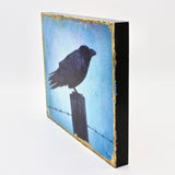 Raven on A Post in Blue By Russell Ryan